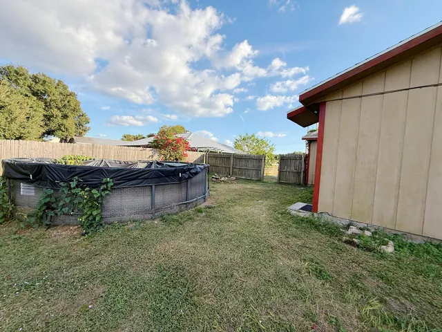 a view of a backyard with plants and a patio