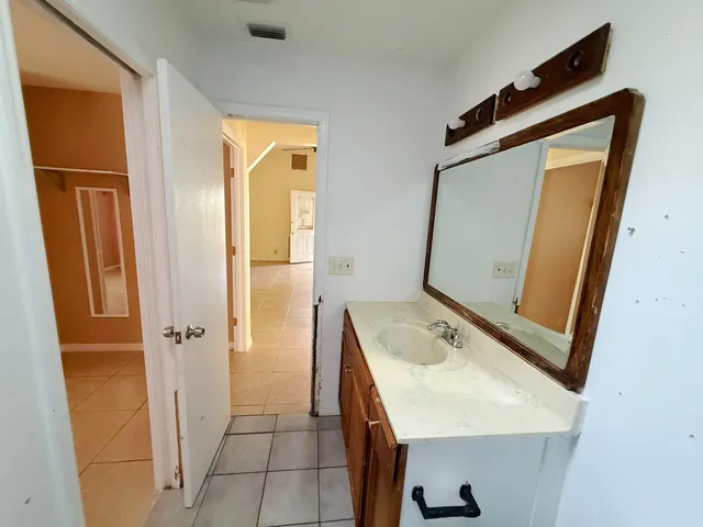 a bathroom with a sink a mirror and shower