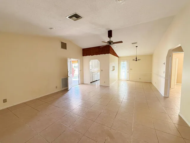 a view of a livingroom with wooden floor and a ceiling fan