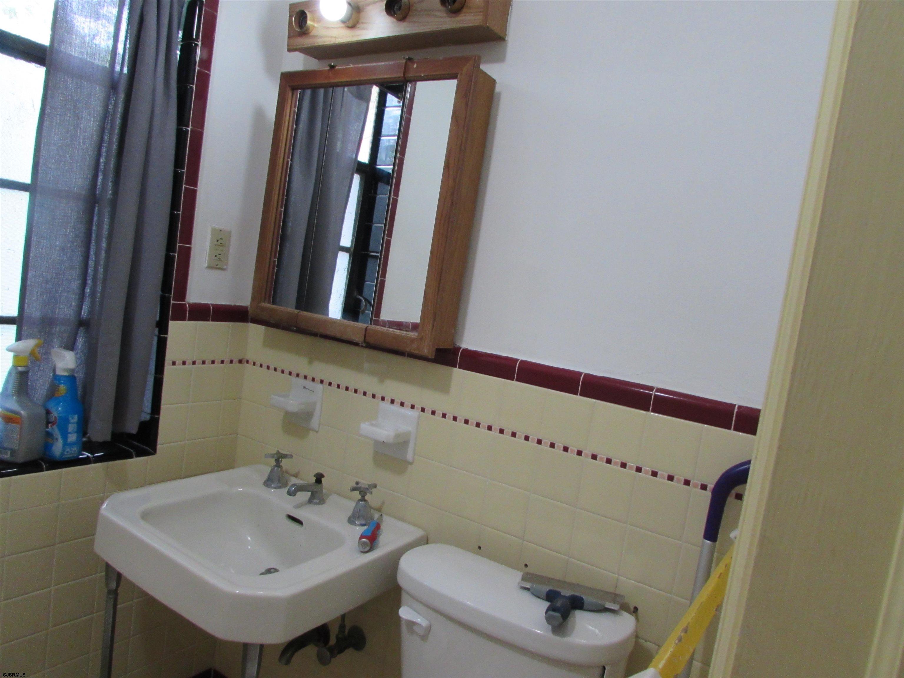 744 Shore Road Linwood, NJ 08221 - Photo 30 of 43 a bathroom with a sink and a mirror