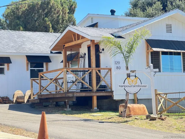 a view of house with backyard space and sitting area