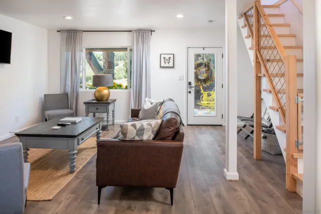 a living room with furniture and a wooden floor