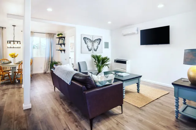 a living room with furniture a flat screen tv and a rug