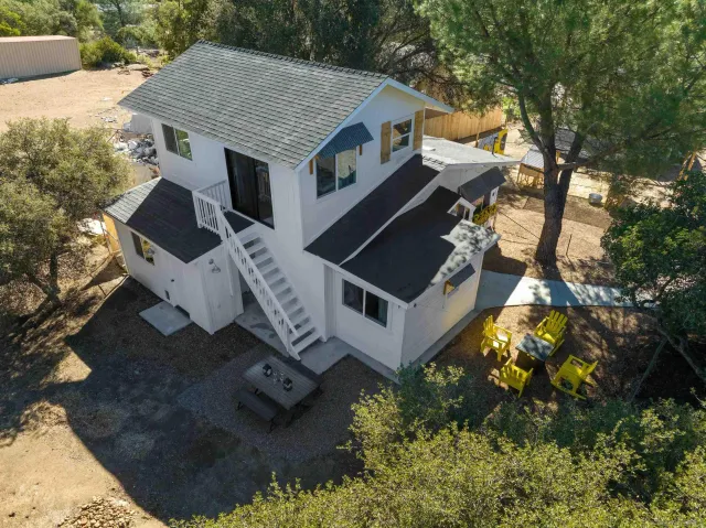 an aerial view of a house with a yard