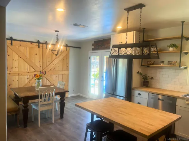 a kitchen with kitchen island a table and chairs in it