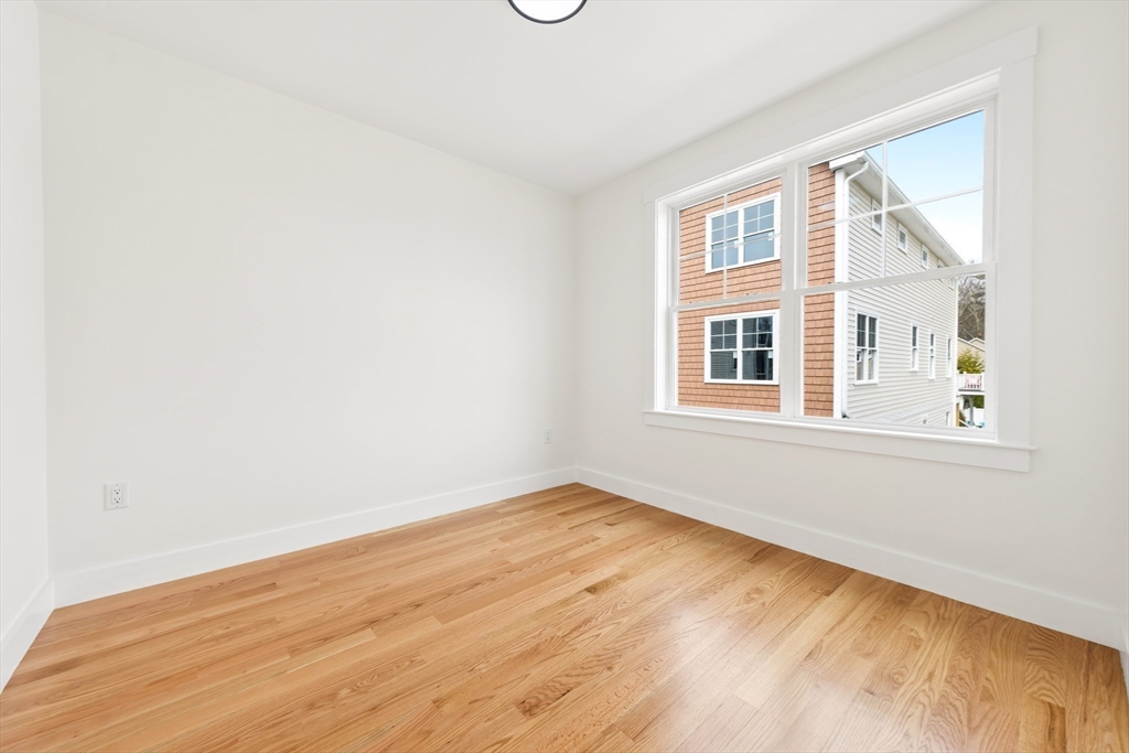 2 Old County Road, Unit 12 Salisbury, MA 01952 - Photo 14 of 29 a view of an empty room with wooden floor and a window