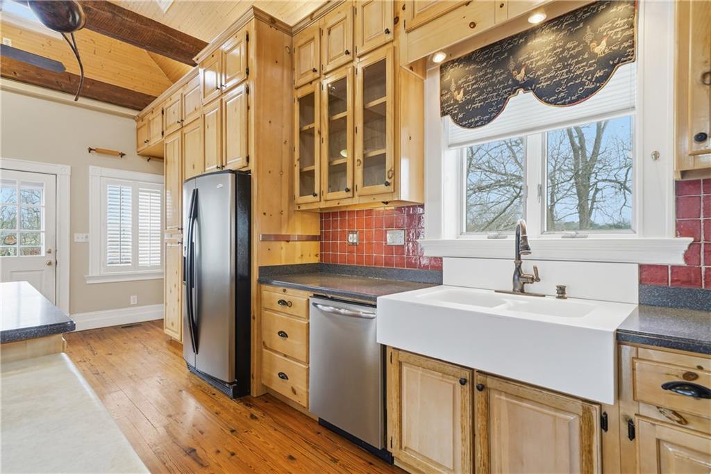 880 Johnstonville Road Barnesville, GA 30204 - Photo 11 of 33 a kitchen with stainless steel appliances a sink a stove and a refrigerator with wooden floor