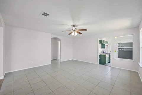 wooden floor in an empty room with a kitchen