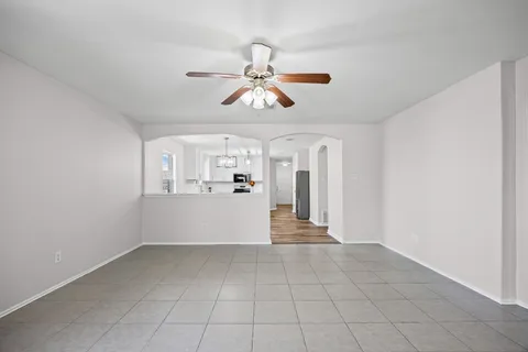 a view of a kitchen with wooden cabinet and a ceiling fan
