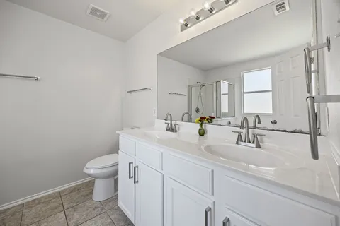 a bathroom with a sink a toilet and mirror