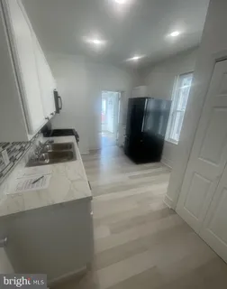 a kitchen with a sink and a refrigerator