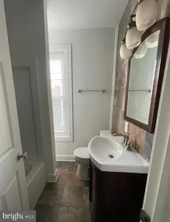a bathroom with a sink a toilet and a bathtub