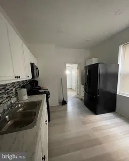 a kitchen with a refrigerator and a stove