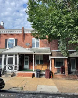 a front view of a house with a yard and glass windows