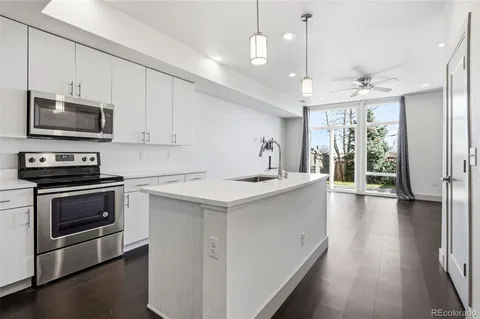 a kitchen with a stove a sink and a microwave