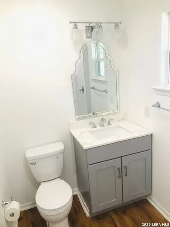 a bathroom with a toilet sink and mirror
