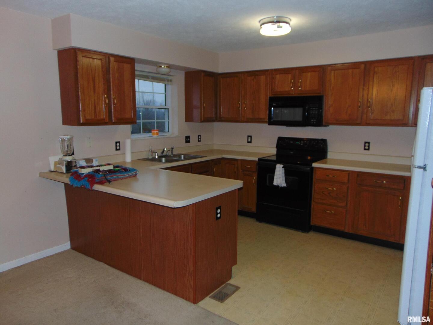 44 Bud Road Alto Pass, IL 62905 - Photo 14 of 21 a kitchen with stainless steel appliances granite countertop a sink stove and cabinets