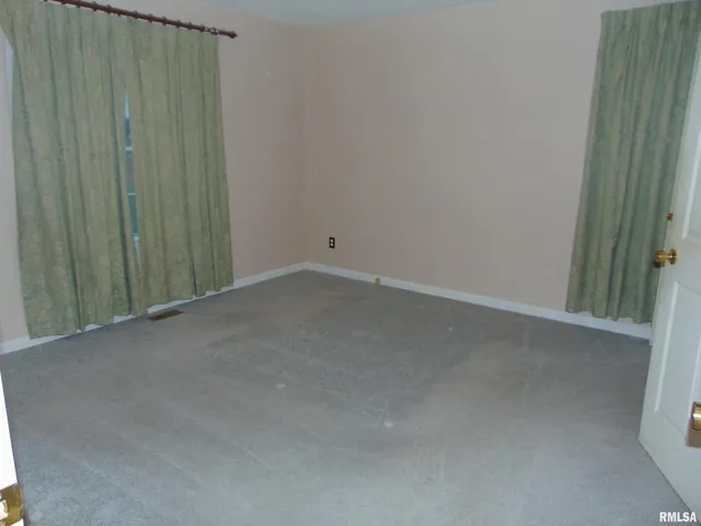 a view of a closet and wooden floor