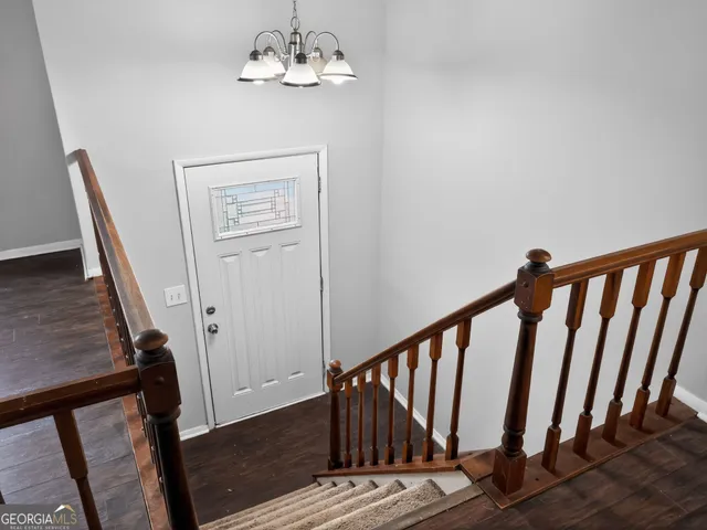 a view of entryway with stairs and wooden floor