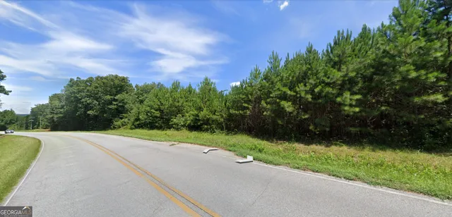a view of a street with a yard
