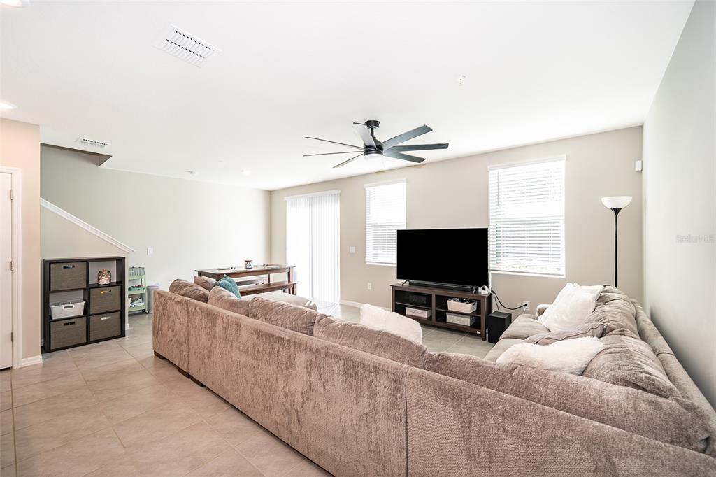 2555 Sweet Viburnum Way Ocoee, FL 34761 - Photo 13 of 26 a living room with furniture and a flat screen tv