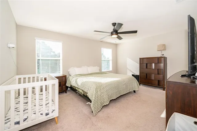 a bedroom with a bed a dresser and a window