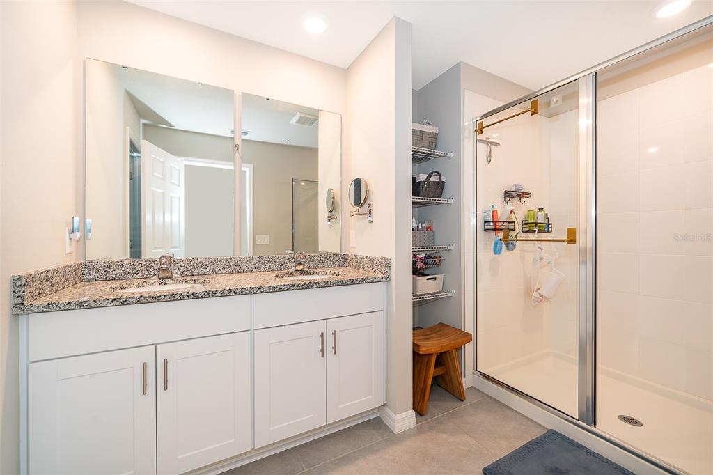 2555 Sweet Viburnum Way Ocoee, FL 34761 - Photo 17 of 26 a bathroom with a granite countertop sink and a mirror