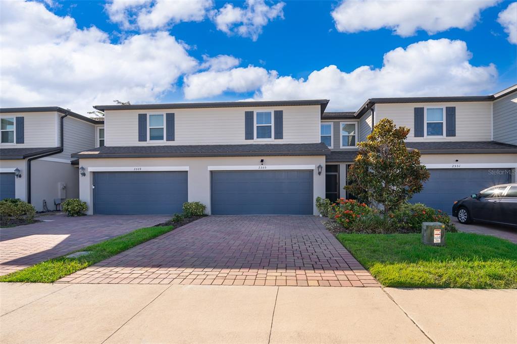 2555 Sweet Viburnum Way Ocoee, FL 34761 - Photo 2 of 26 front view of a house with a yard