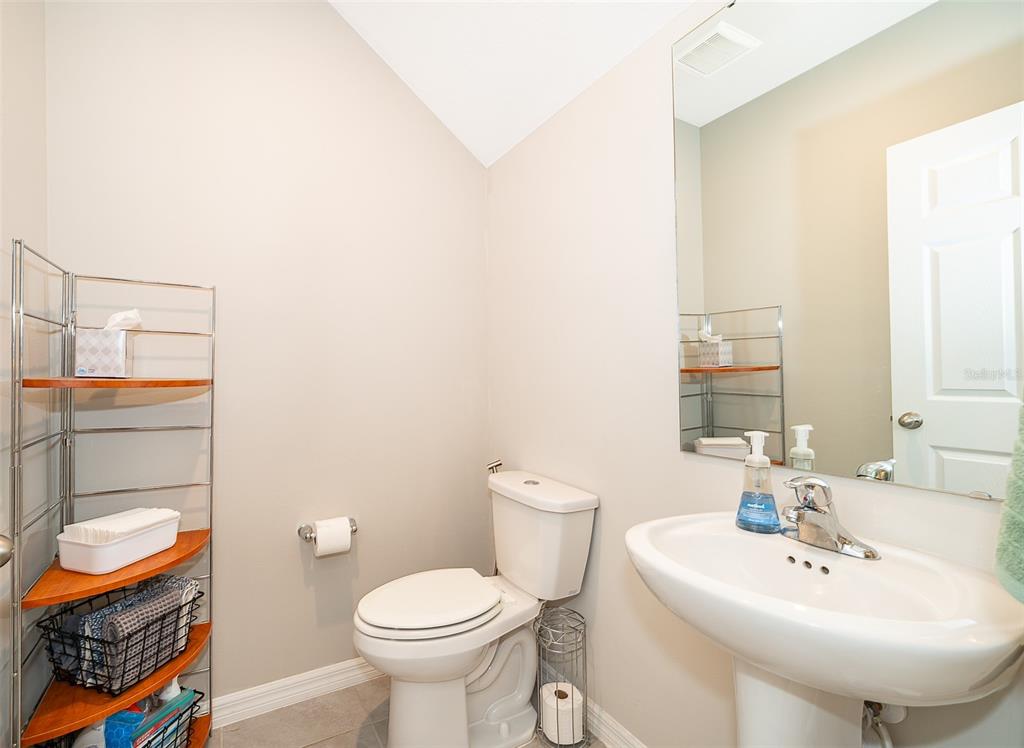 2555 Sweet Viburnum Way Ocoee, FL 34761 - Photo 21 of 26 a bathroom with a sink a toilet and a mirror