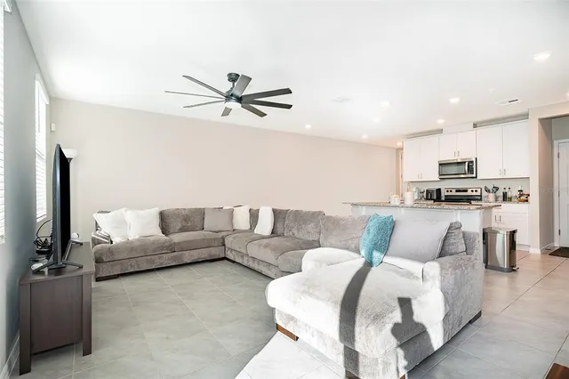a living room with furniture and kitchen view