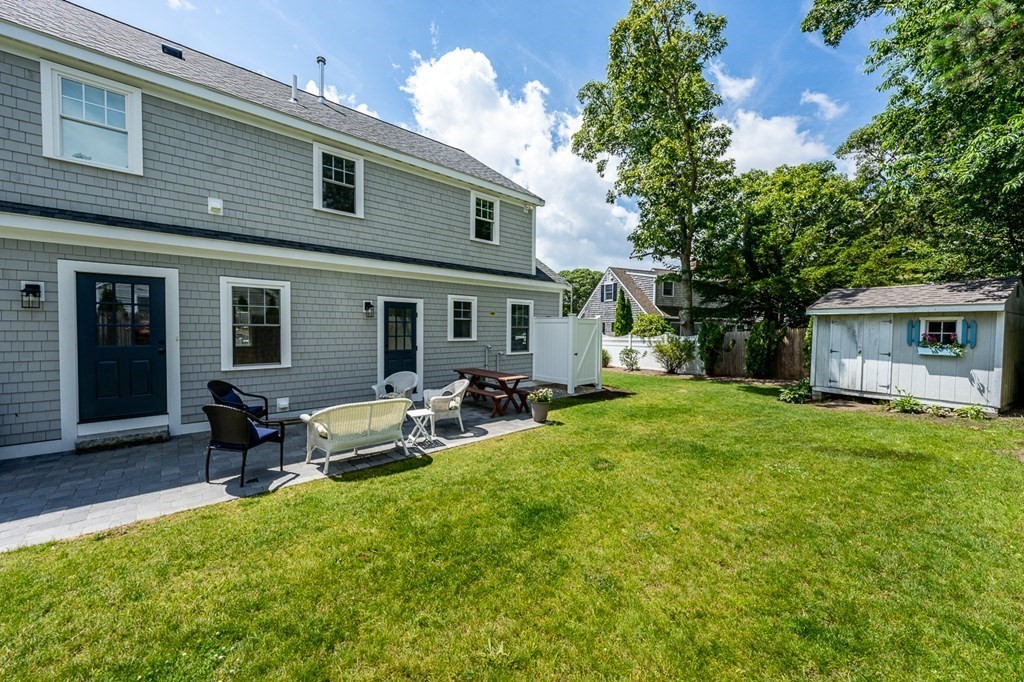 180 Lower County Road West Harwich, MA 02671 - Photo 3 of 18 a view of a house with backyard and sitting area