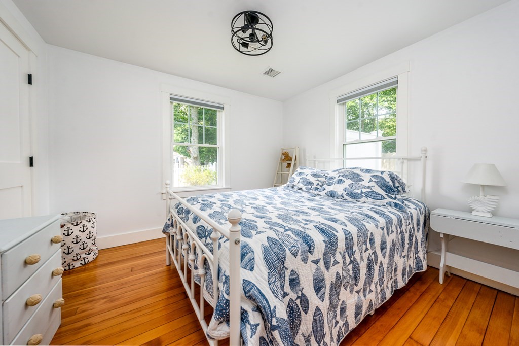 180 Lower County Road West Harwich, MA 02671 - Photo 7 of 18 a bedroom with a bed and a window