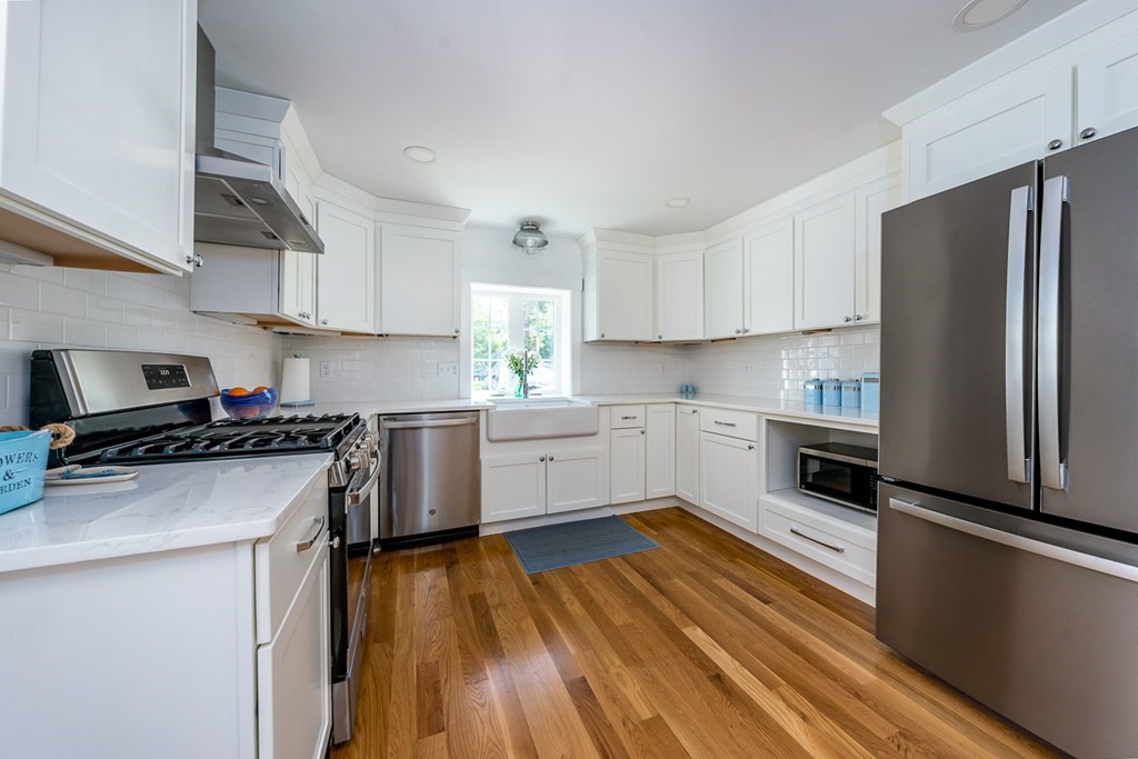 180 Lower County Road West Harwich, MA 02671 - Photo 8 of 18 a kitchen with granite countertop a refrigerator stove top oven and sink
