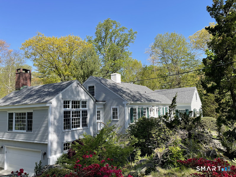 a view of a house with a yard and potted plants