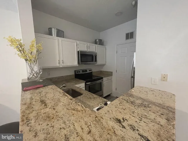 a kitchen with a stove a sink and a microwave