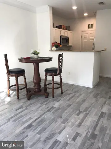 a kitchen with a table chairs and a refrigerator