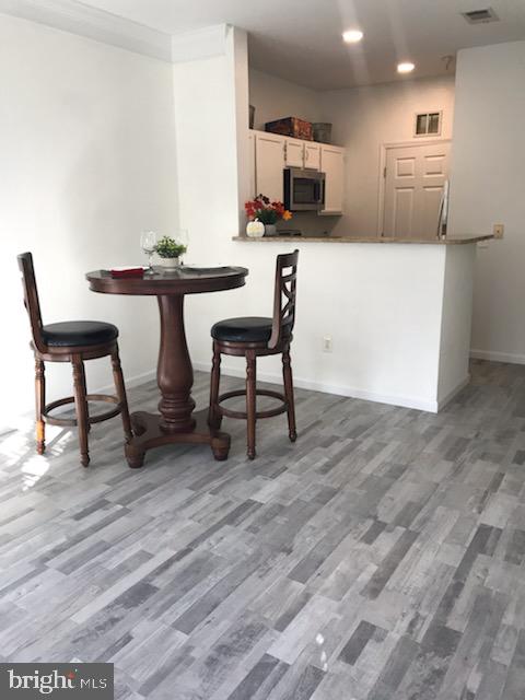 1521 Spring Gate Dr., Unit 10102 McLean, VA 22102 - Photo 14 of 46 a kitchen with a table chairs and a refrigerator