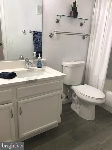 a white toilet sitting next to a bathroom sink