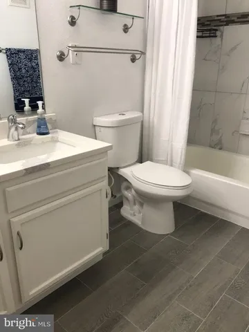 a bathroom with a toilet sink and shower
