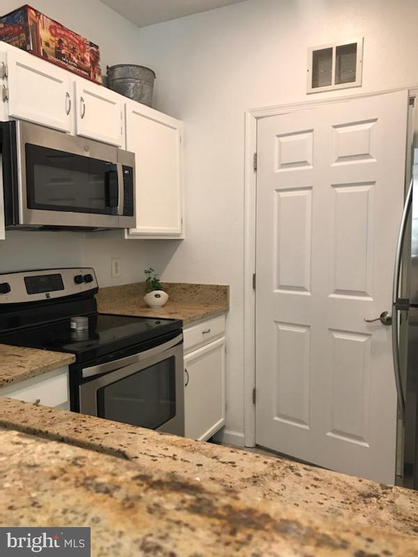 1521 Spring Gate Dr., Unit 10102 McLean, VA 22102 - Photo 27 of 46 a bathroom with a sink and a microwave