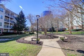 1521 Spring Gate Dr., Unit 10102 McLean, VA 22102 - Photo 28 of 46 a view of a fountain in front of a brick building