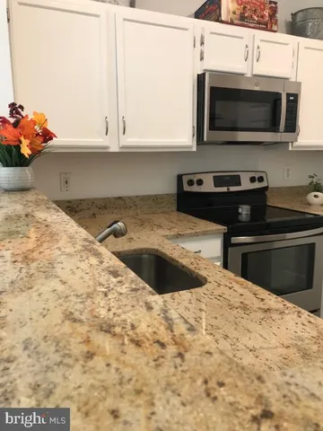 a kitchen with a stove and a microwave