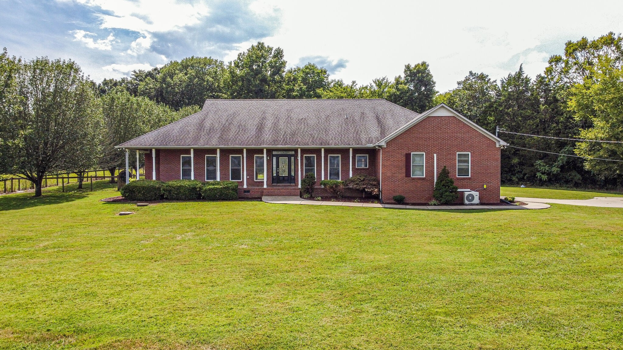 1950 Carpenter Bridge Road Columbia, TN 38401 - Photo 1 of 50 a front view of a house with a garden and swimming pool