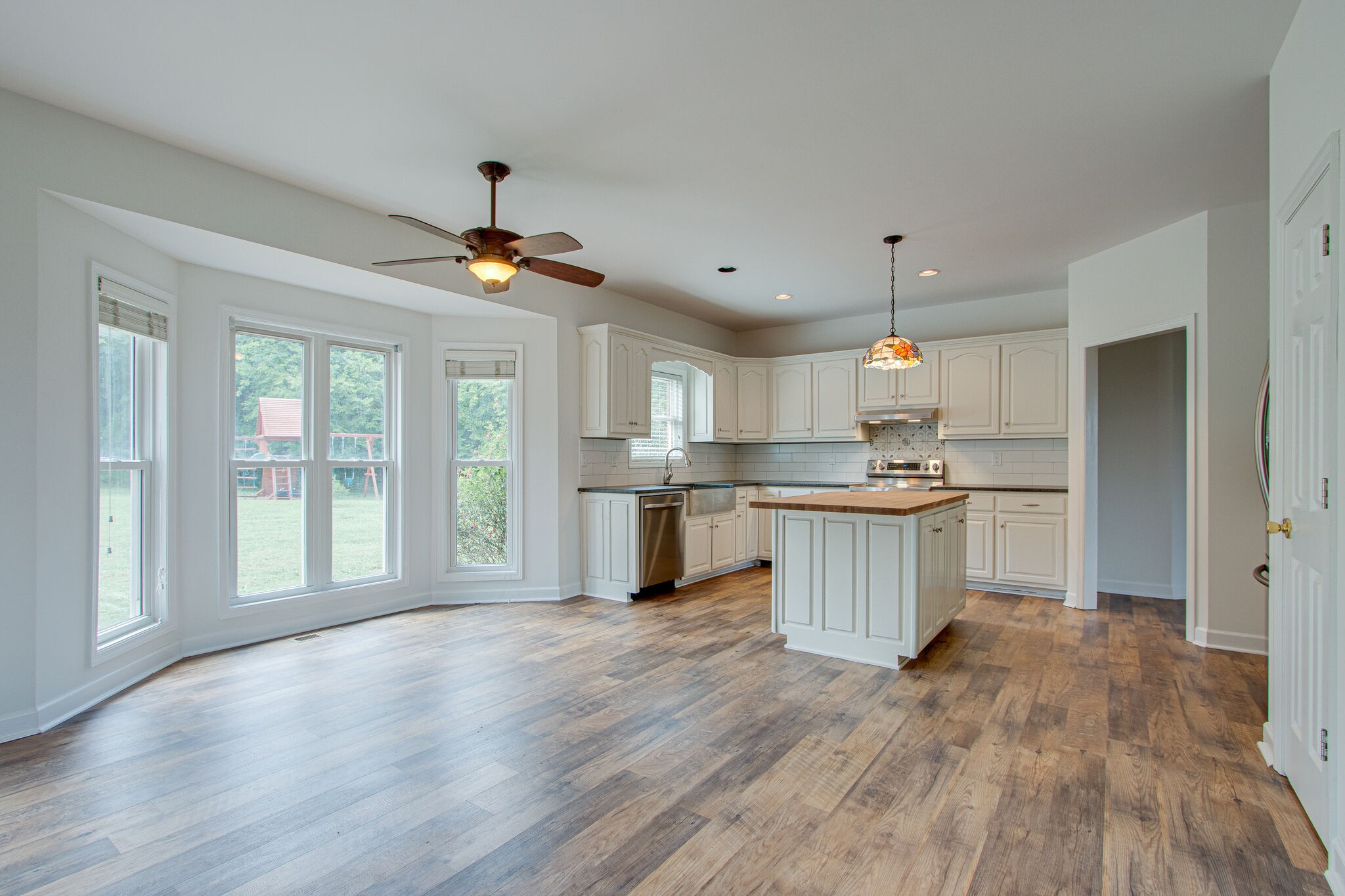 1950 Carpenter Bridge Road Columbia, TN 38401 - Photo 13 of 50 a open kitchen with white cabinets and wooden floor