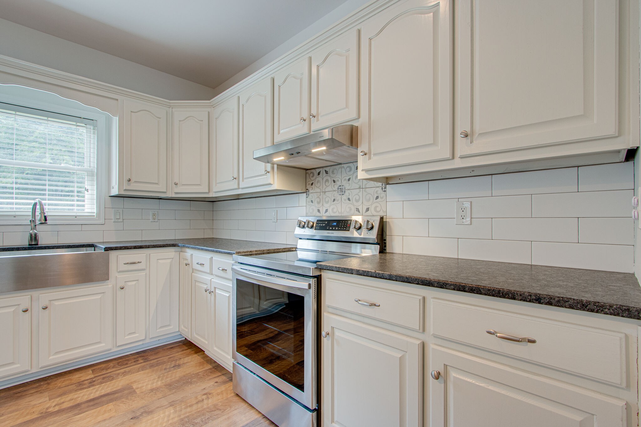 1950 Carpenter Bridge Road Columbia, TN 38401 - Photo 19 of 50 a kitchen with granite countertop white cabinets and white appliances