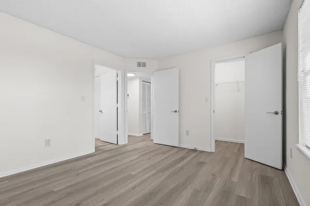 a view of an empty room and wooden floor