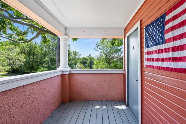 a view of balcony with wooden floor