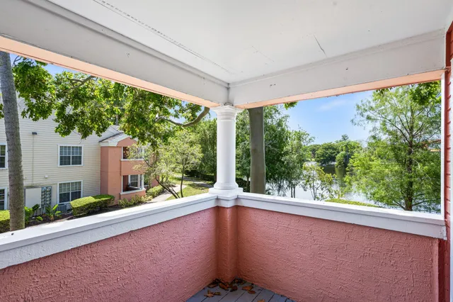 a view of balcony with floor to ceiling windows and wooden fence