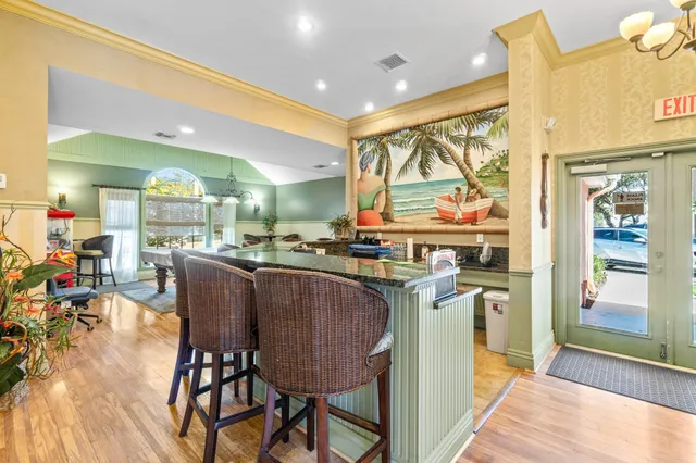 a dining hall with stainless steel appliances a dining table and chairs