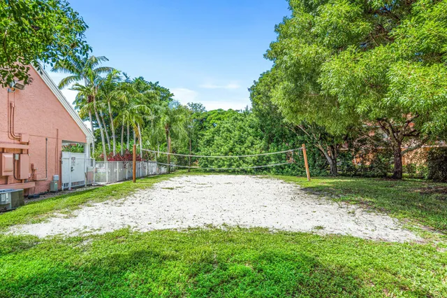 a backyard of a house with plants and large trees